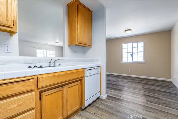 a bathroom with a granite countertop toilet sink and mirror