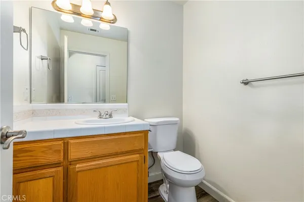 an empty room with ceiling fan and windows