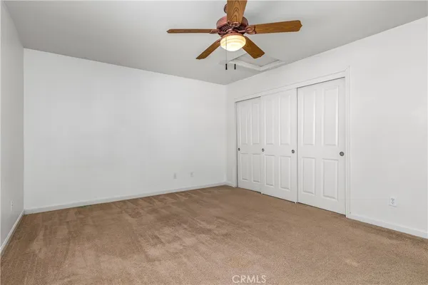 a view of a big room with chandelier fan and a chandelier fan