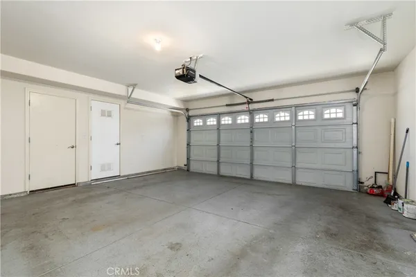 an empty room with an entryway and fan
