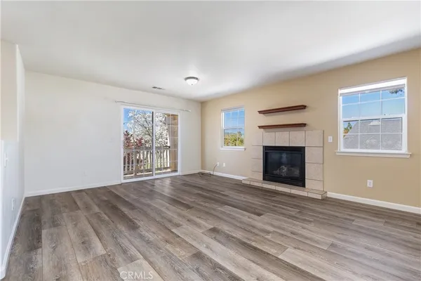 a living room with a fireplace and a window