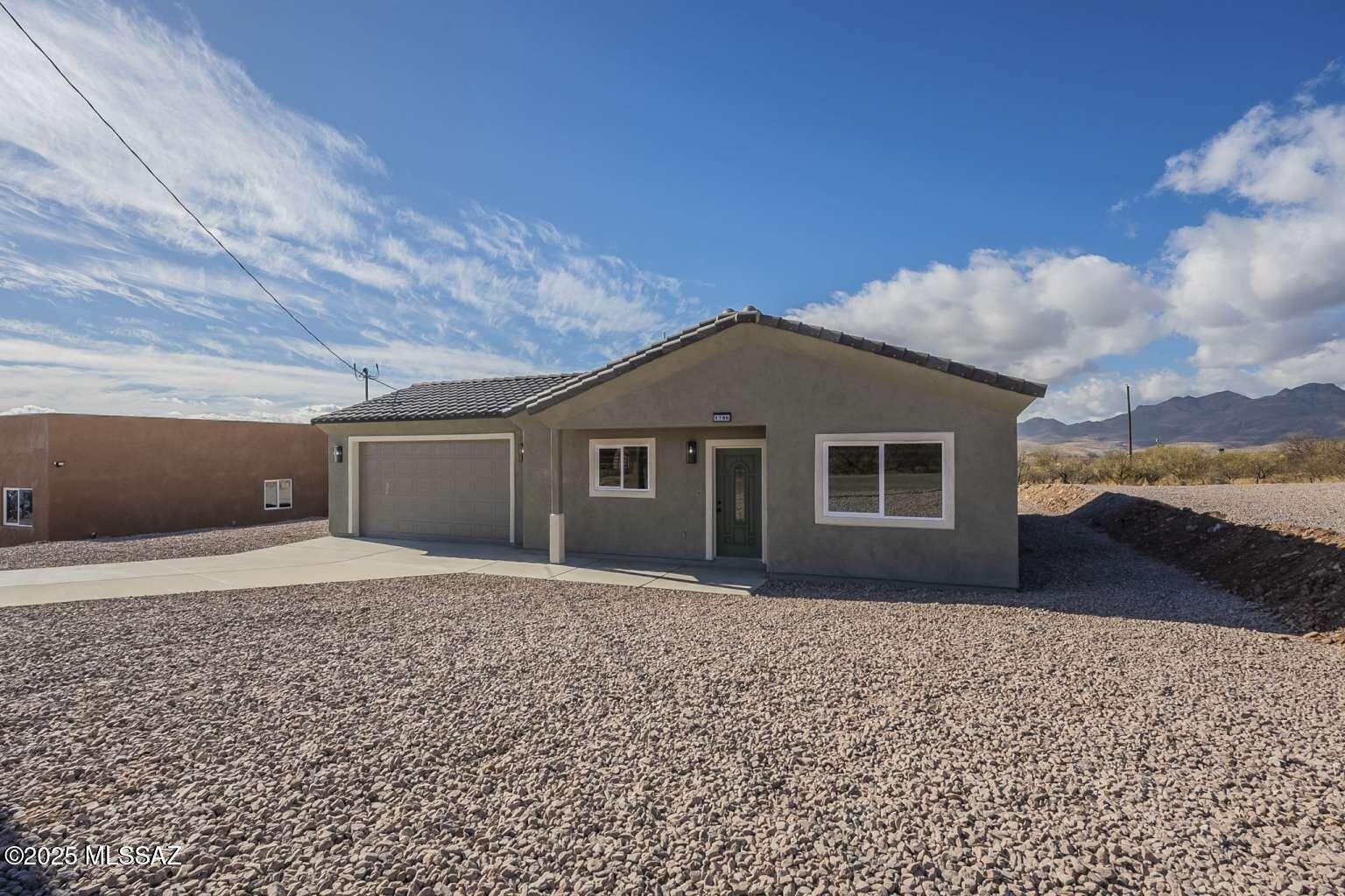 1796 Cajeme Court Rio Rico, AZ 85648 - Photo 2 of 45 a front view of a house with a yard