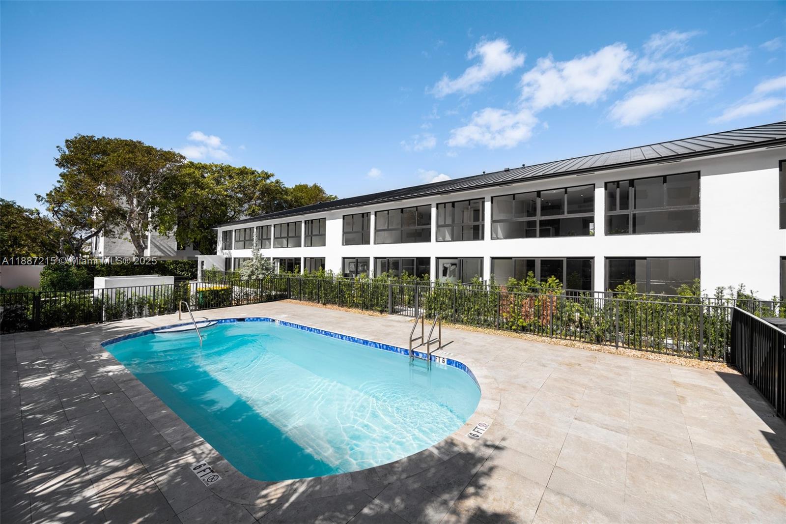 200 Sunrise Drive, Unit 200D Key Biscayne, FL 33149 - Photo 23 of 30 a view of a house with swimming pool and sitting area