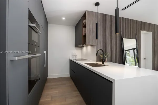 a kitchen with a sink and a refrigerator