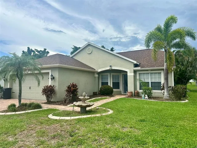 a front view of a house with a yard and outdoor seating