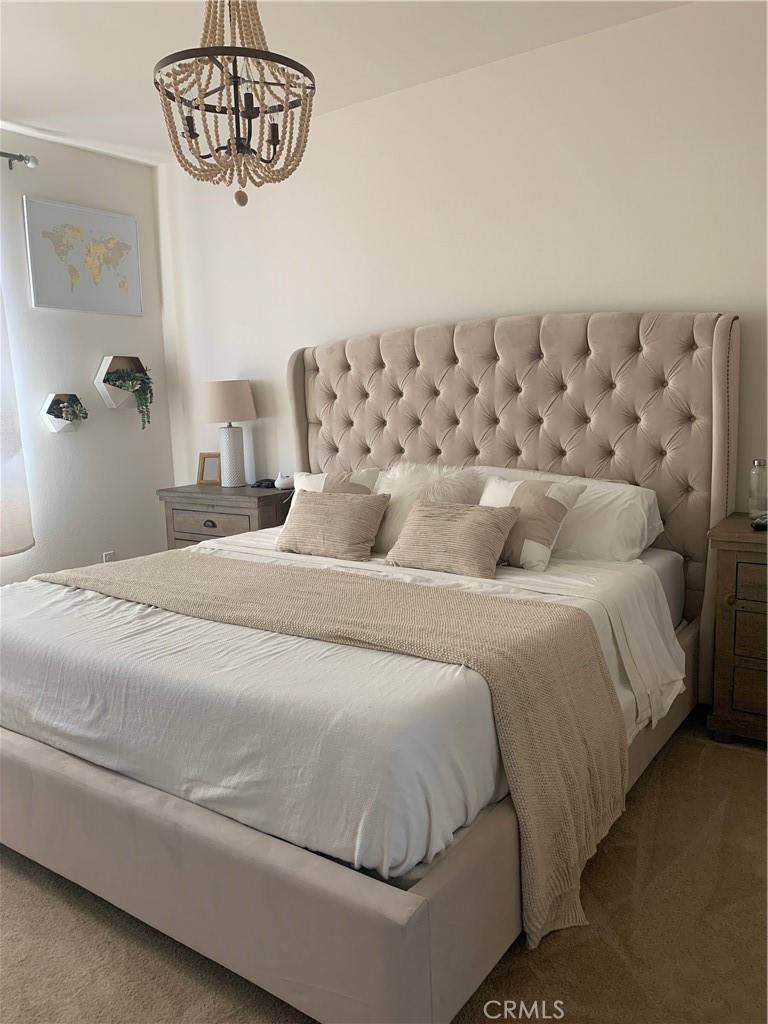 2017 Tango Loop, Unit 1 Chula Vista, CA 91915 - Photo 9 of 32 a bedroom with a bed and a chandelier