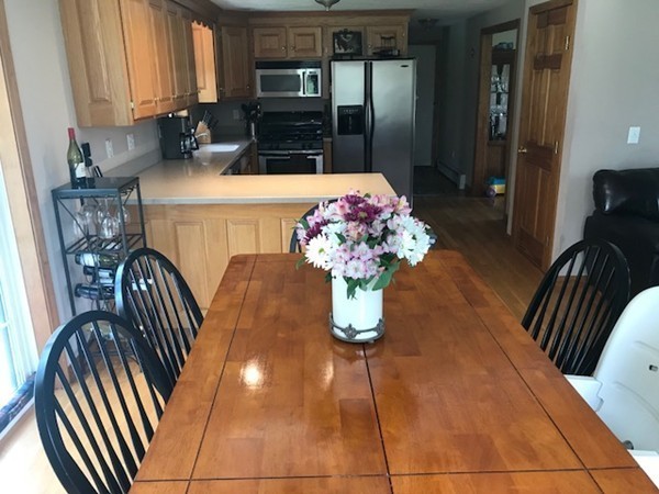 487 Sheldon Road Fitchburg, MA 01420 - Photo 15 of 27 a dining room with furniture and chandelier