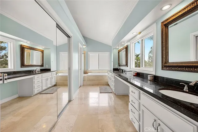 a large kitchen with a large counter top and stainless steel appliances