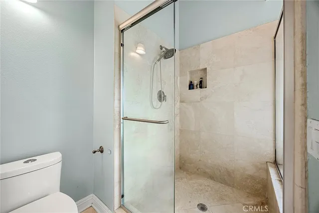 a bathroom with a shower and toilet