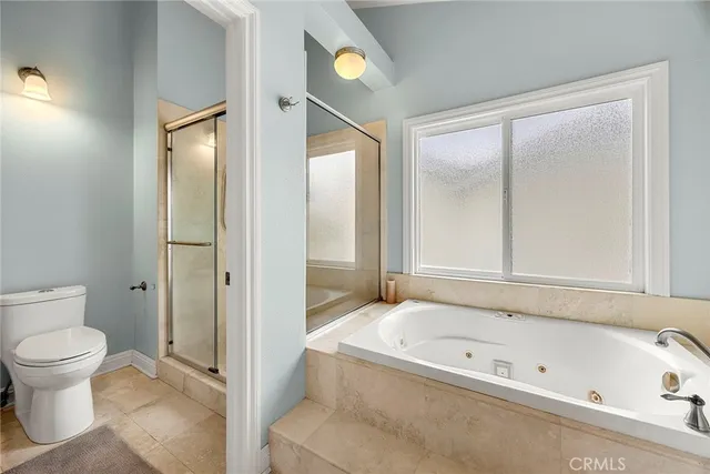 a bathroom with a tub and toilet