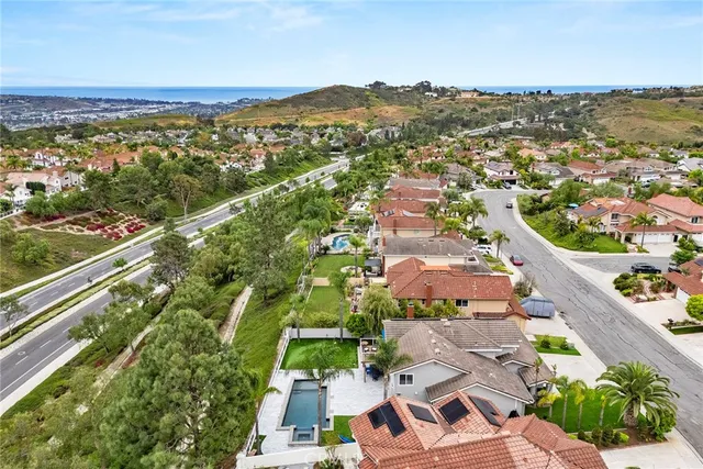 an aerial view of residential houses with outdoor space