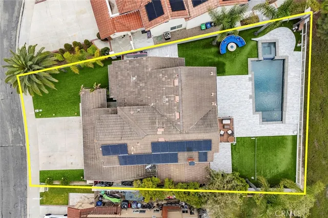 an aerial view of a house with a yard and lake view