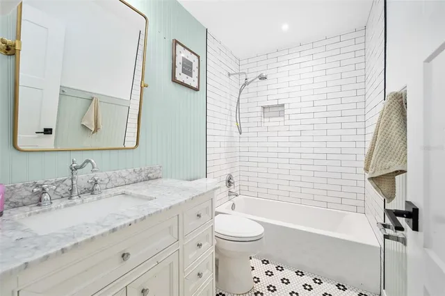 a large kitchen with stainless steel appliances a sink a counter top space and cabinets