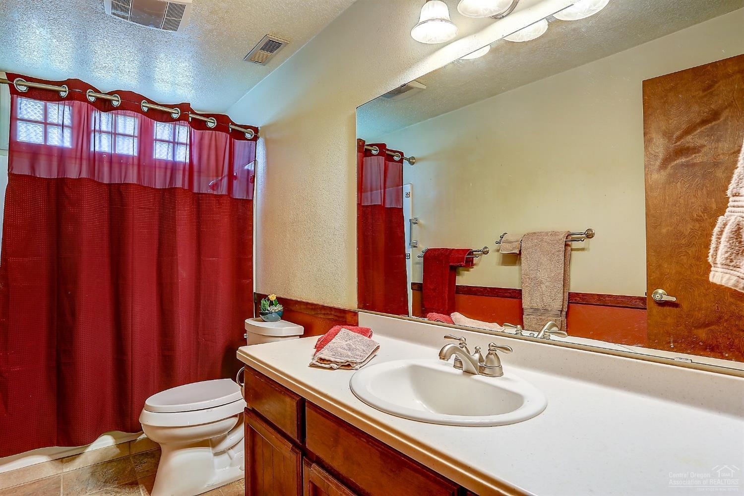 20358 Donkey Sled Road Bend, OR 97702 - Photo 15 of 17 a bathroom with a sink a toilet and shower