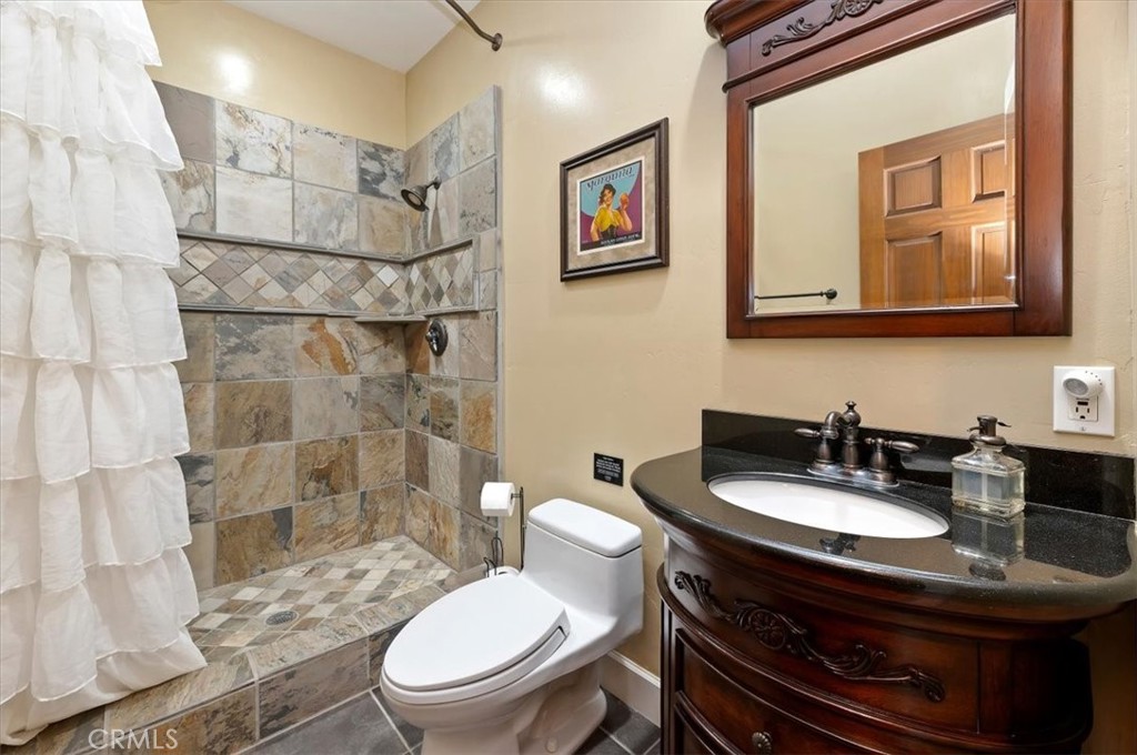 16420 Rocky Glen Road Perris, CA 92570 - Photo 36 of 74 a bathroom with a sink toilet and a mirror