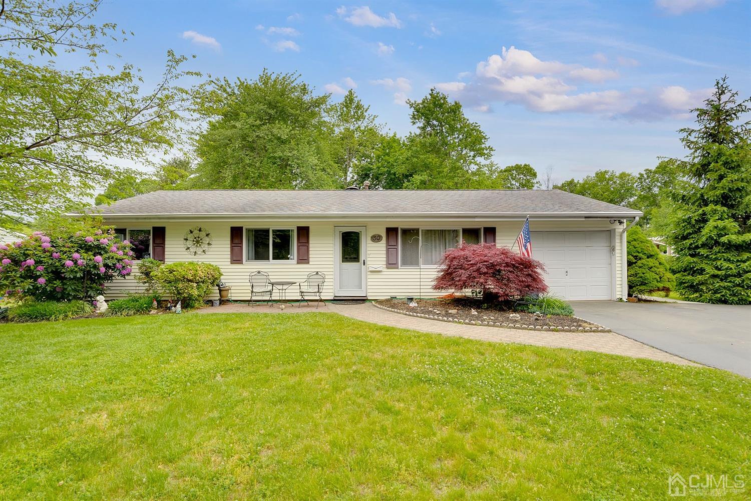 a front view of house with yard and green space