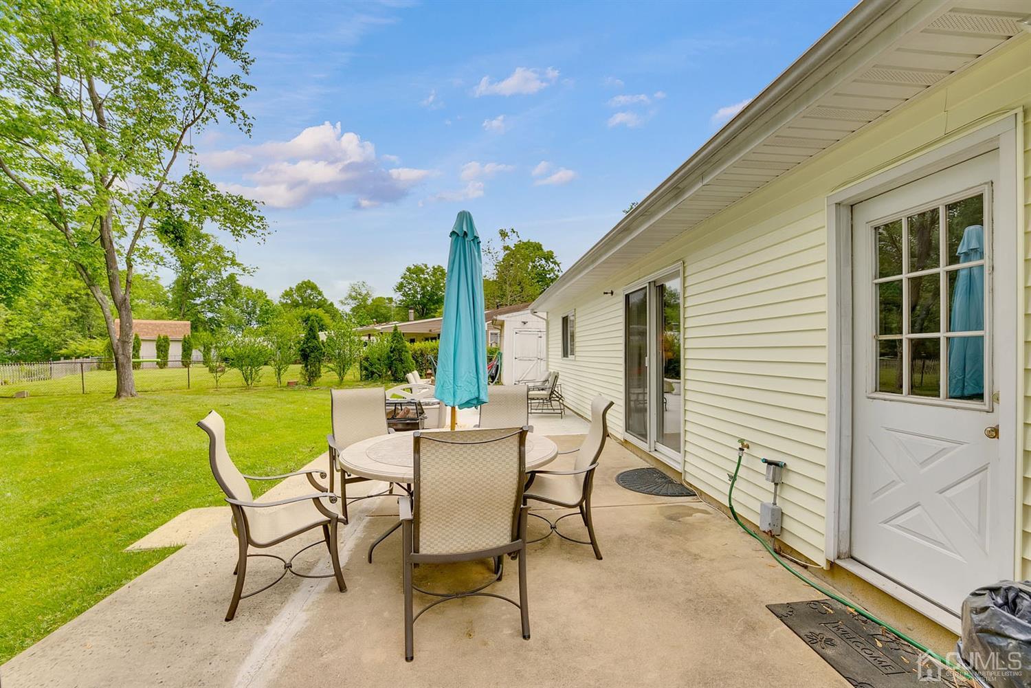 30 Savage Road Kendall Park, NJ 08824 - Photo 19 of 20 a view of a house with backyard sitting area and garden