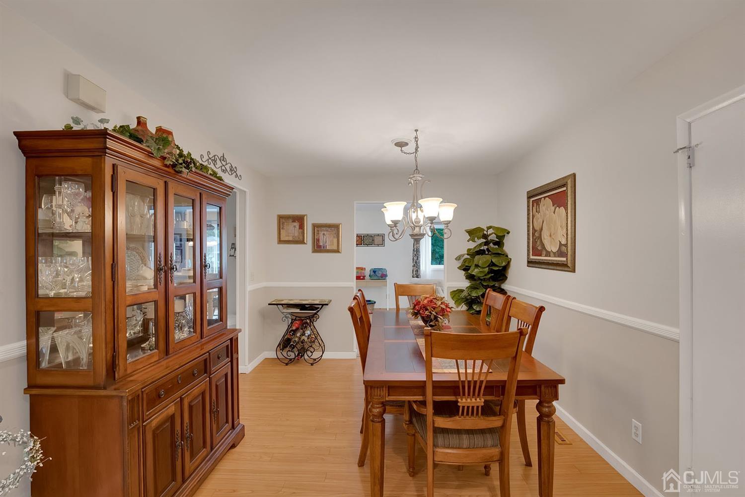 30 Savage Road Kendall Park, NJ 08824 - Photo 7 of 20 a view of a dining room with furniture and a chandelier