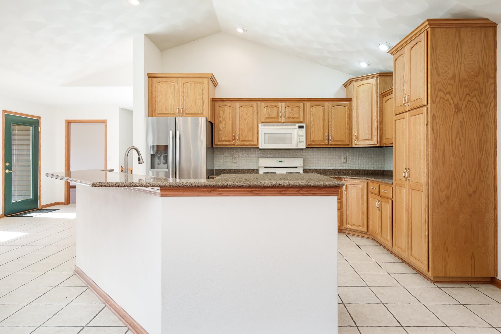 261 West Redtail Lane Oregon, IL 61061 - Photo 12 of 63 a kitchen with kitchen island cabinets and refrigerator