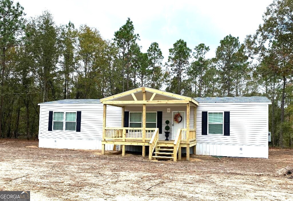 519 Wilson Road Twin City, GA 30471 - Photo 1 of 20 a view of a house with a patio and a yard