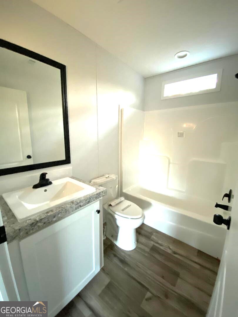 519 Wilson Road Twin City, GA 30471 - Photo 12 of 20 a bathroom with a granite countertop sink toilet and mirror