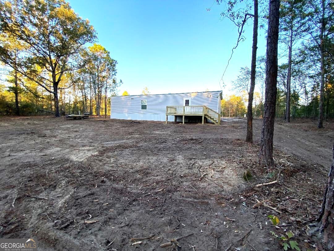 519 Wilson Road Twin City, GA 30471 - Photo 13 of 20 a view of a yard with utility and trees