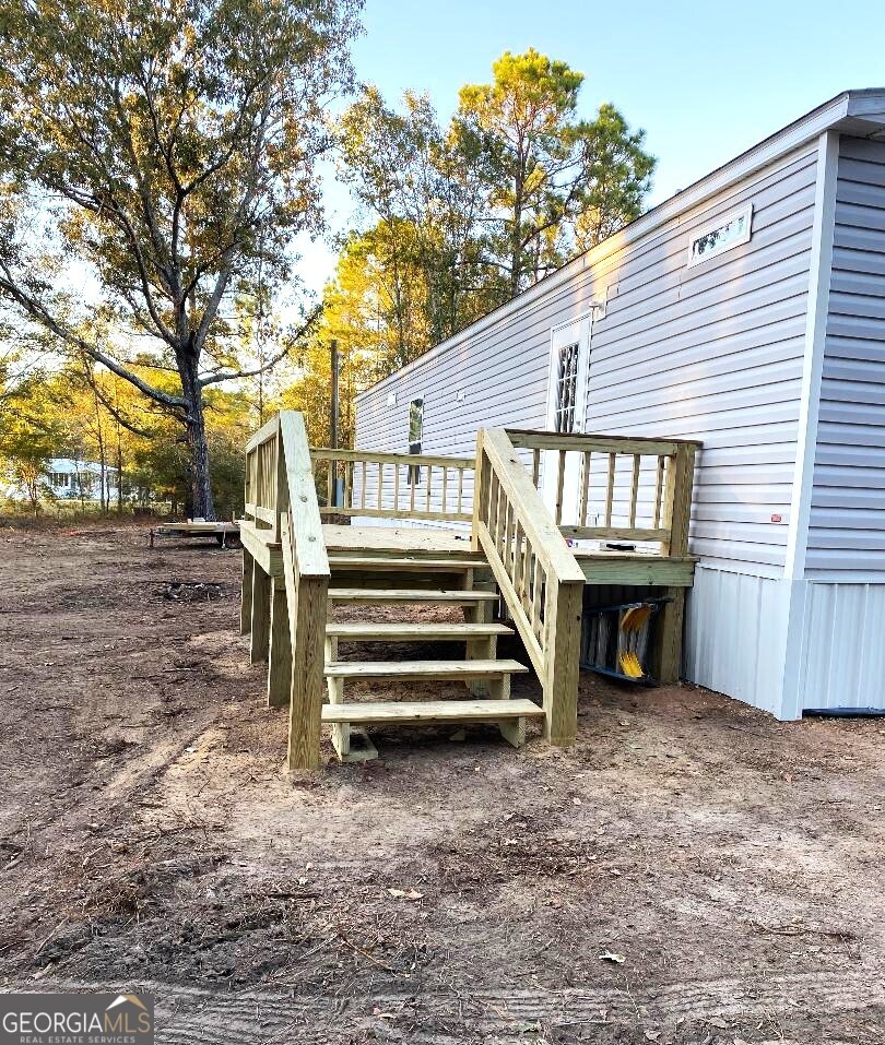 519 Wilson Road Twin City, GA 30471 - Photo 15 of 20 a view of a house with a yard and stairs