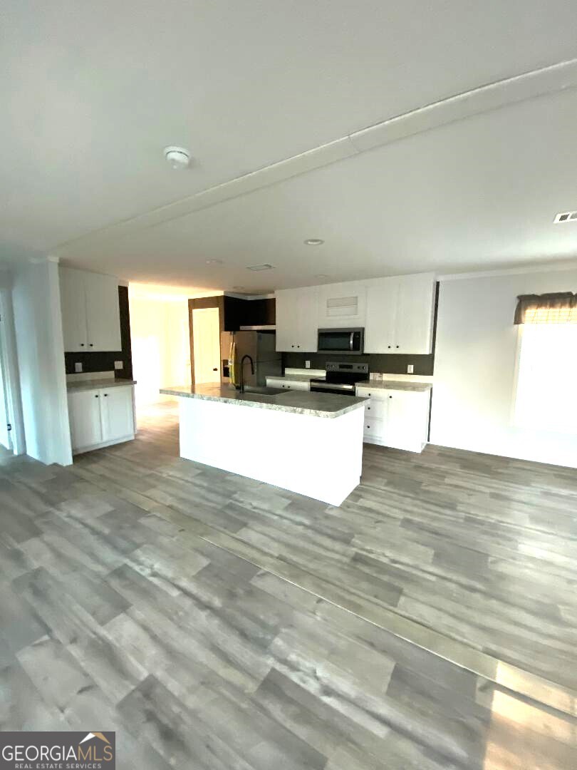 519 Wilson Road Twin City, GA 30471 - Photo 4 of 20 a view of a kitchen with microwave and cabinets