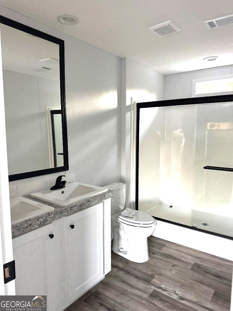 519 Wilson Road Twin City, GA 30471 - Photo 8 of 20 a bathroom with a granite countertop sink and a mirror