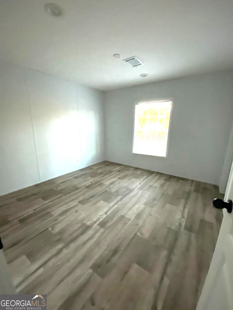 519 Wilson Road Twin City, GA 30471 - Photo 9 of 20 a view of empty room with window