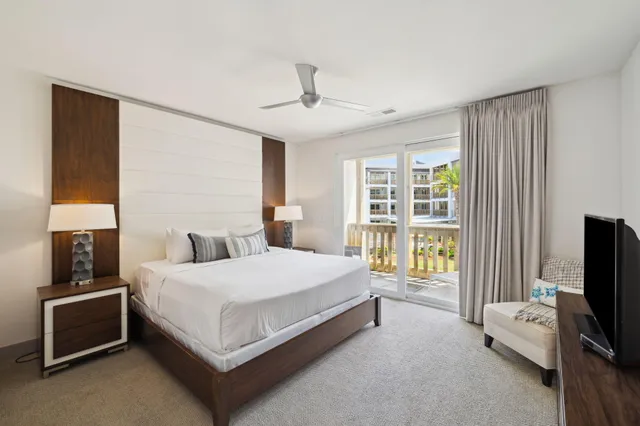 a large bedroom with a bed and large window