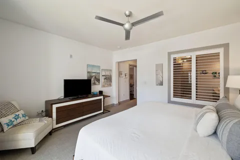 a bedroom with a bed and a television