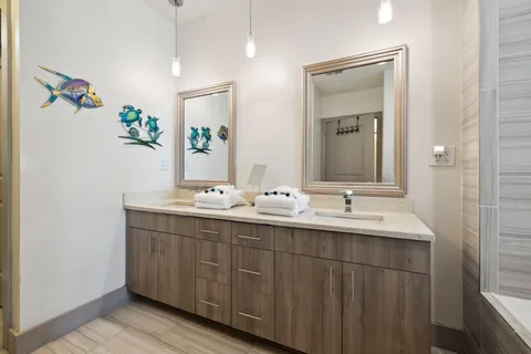 a bathroom with a double vanity sink and a mirror