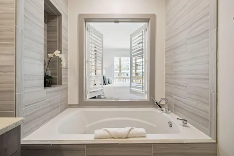 a bathroom with bathtub and window
