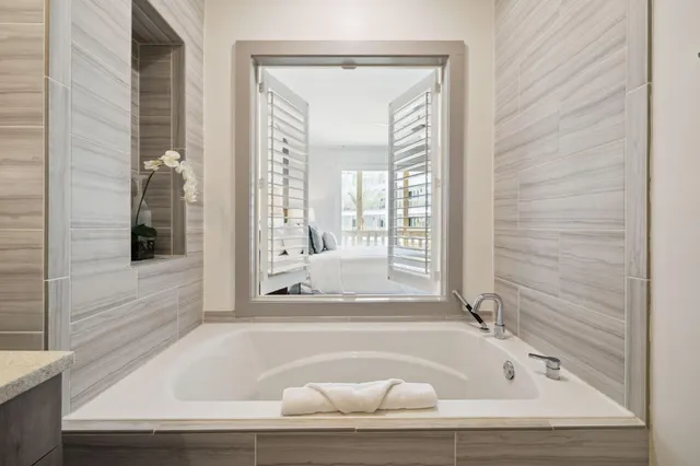 a bathroom with bathtub and window