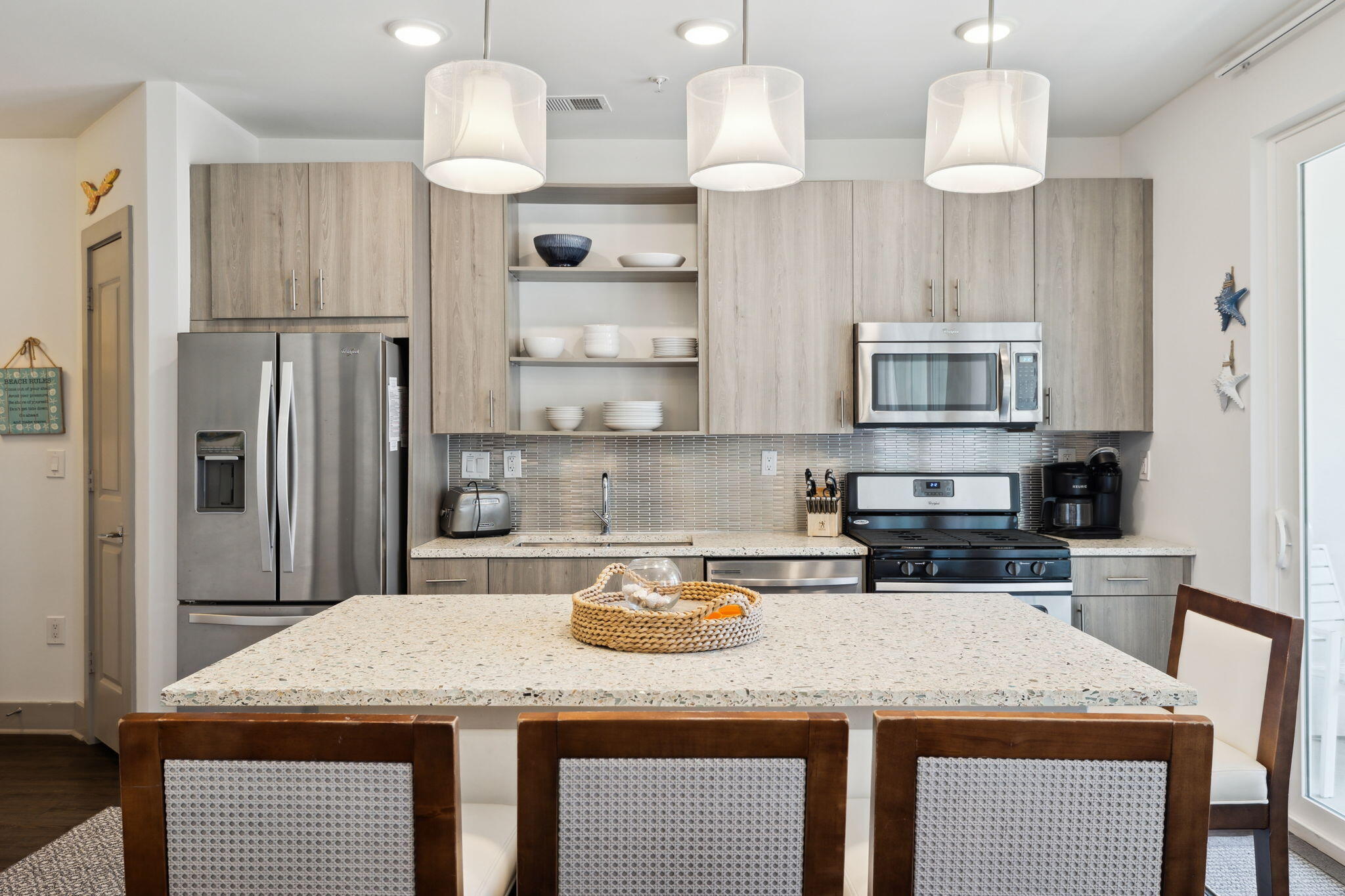 10941 East County Highway 30A, Unit 325 Inlet Beach, FL 32461 - Photo 3 of 36 a kitchen with kitchen island granite countertop a sink a center island and stainless steel appliances