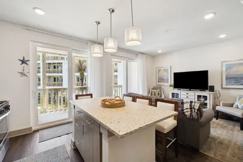 a view of a dining room and livingroom furniture wooden floor and a chandelier