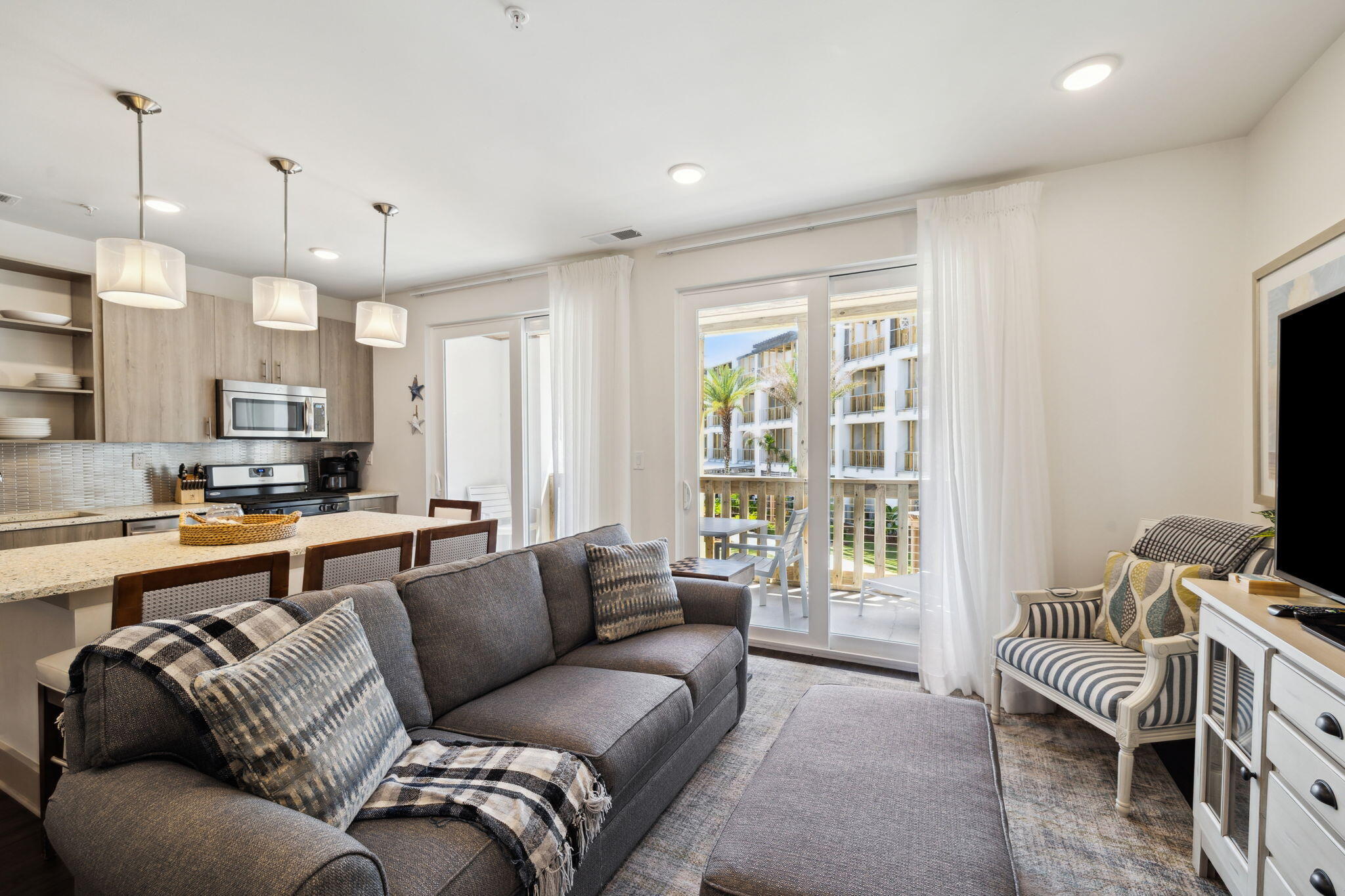 10941 East County Highway 30A, Unit 325 Inlet Beach, FL 32461 - Photo 10 of 36 a living room with furniture a large window and a flat screen tv