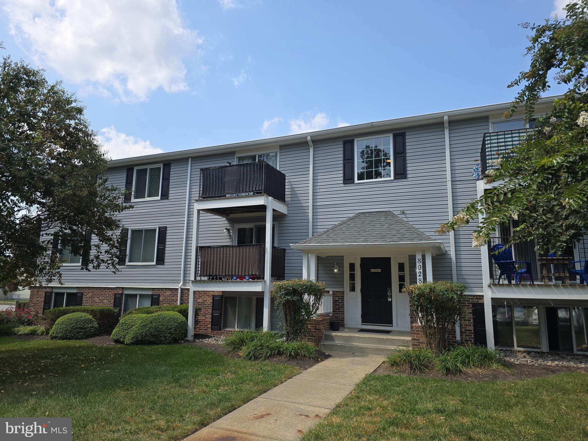 8028 Abbey Court, Unit C Pasadena, MD 21122 - Photo 1 of 12 a front view of a house with garden