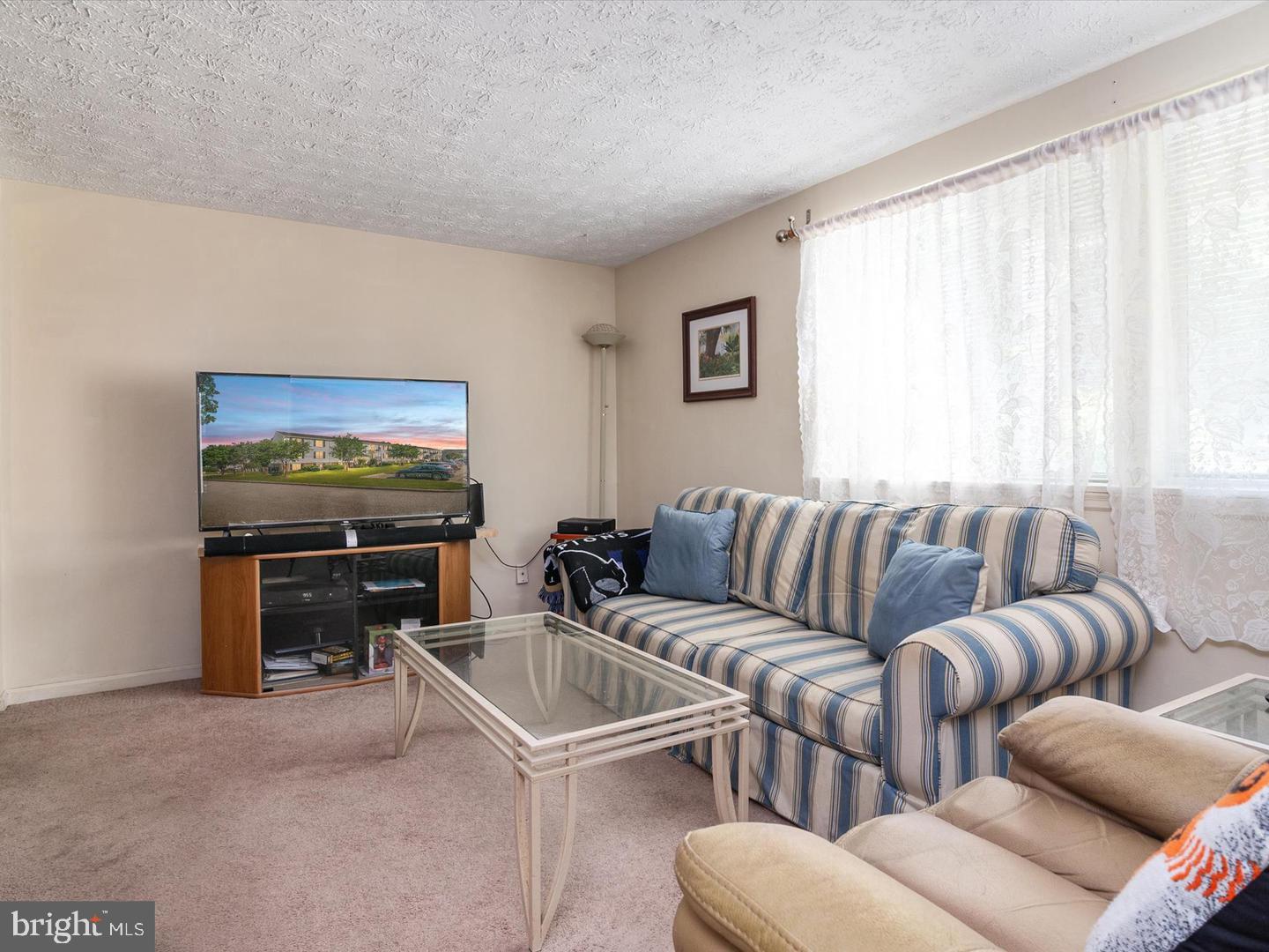 8028 Abbey Court, Unit C Pasadena, MD 21122 - Photo 4 of 12 a living room with furniture and a flat screen tv