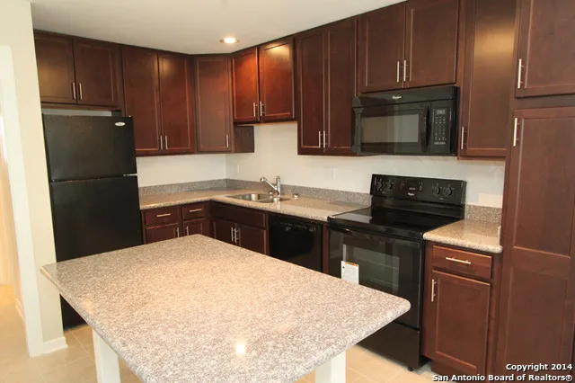 a kitchen with a sink a stove and refrigerator