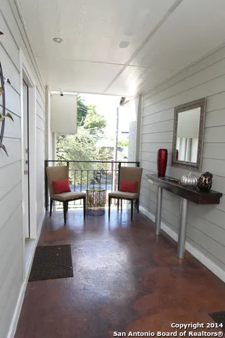 a living room with furniture a dining table and a large window