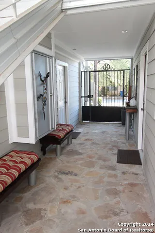 a view of a bedroom with furniture and large window