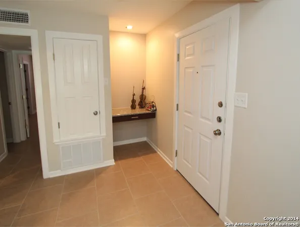 a view of a hallway with closet and bathroom