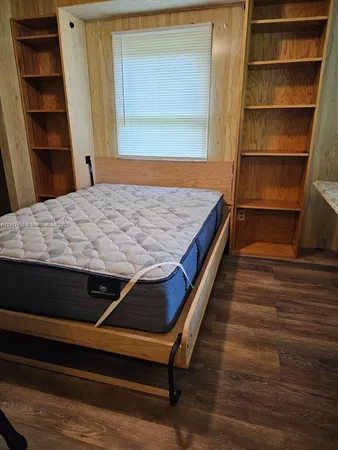 a room with wooden floor and closet