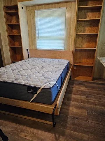 a room with wooden floor and closet