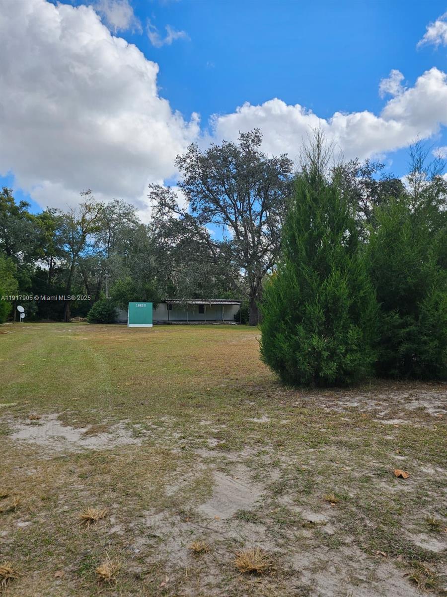 18620 Wildlife Trail, Unit 18620 Spring Hill, FL 34610 - Photo 18 of 19 a view of grassy field with mountain in the background