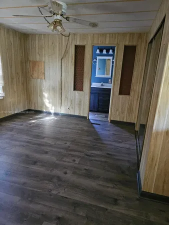 a view of a livingroom with wooden floor and staircase