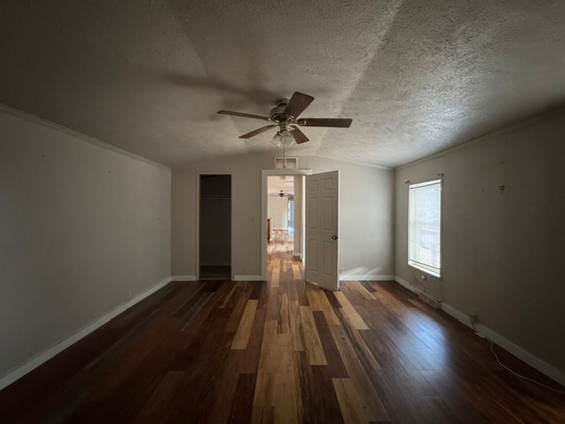 109558 South 4760 Road Muldrow, OK 74948 - Photo 20 of 22 Spacious room featuring multi-tone wood-finish flooring, a ceiling fan, and a window