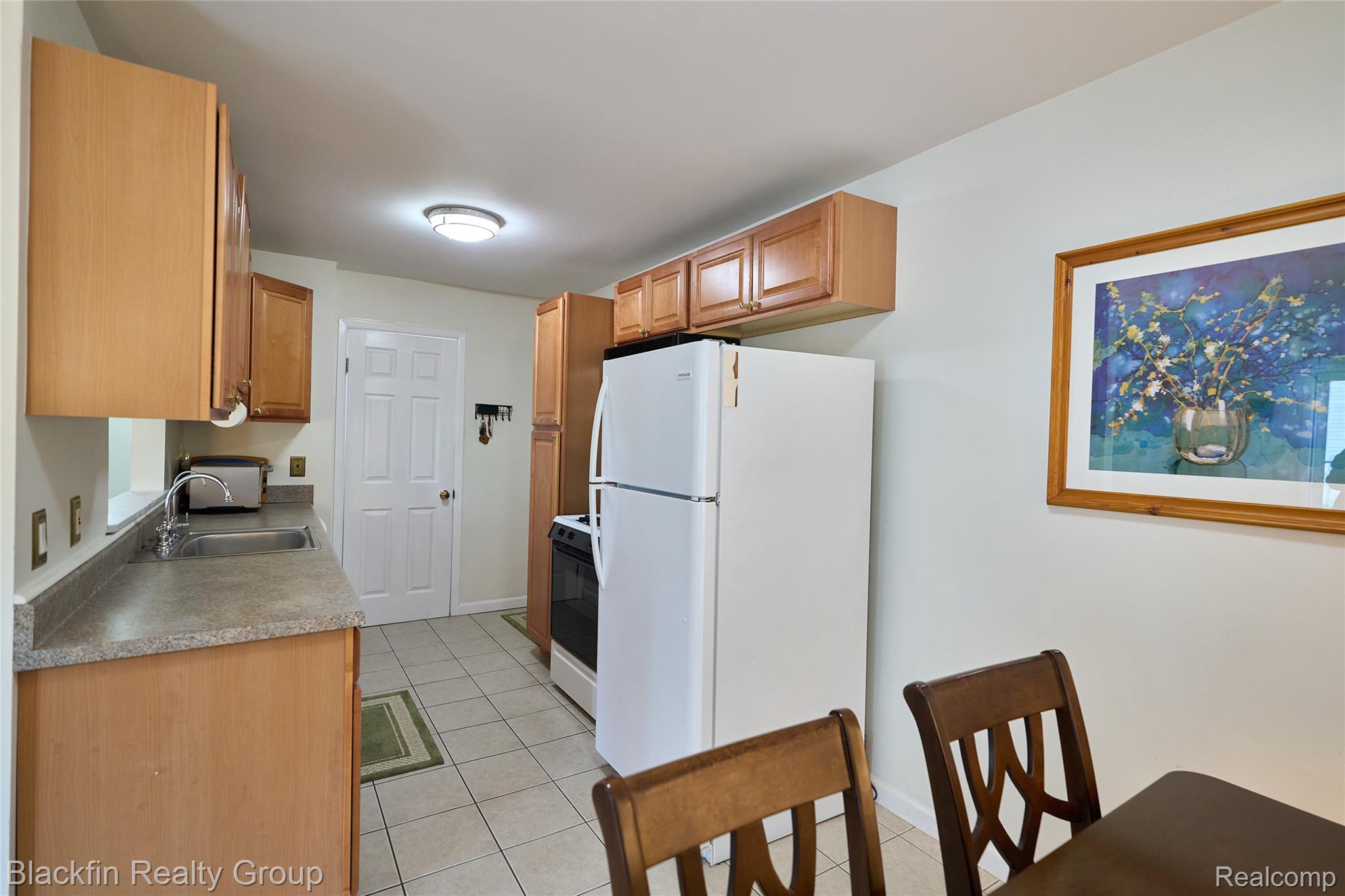 22625 Martin Road St. Clair Shores, MI 48081 - Photo 10 of 23 Kitchen with freestanding refrigerator, light tile patterned flooring, stove, and light countertops